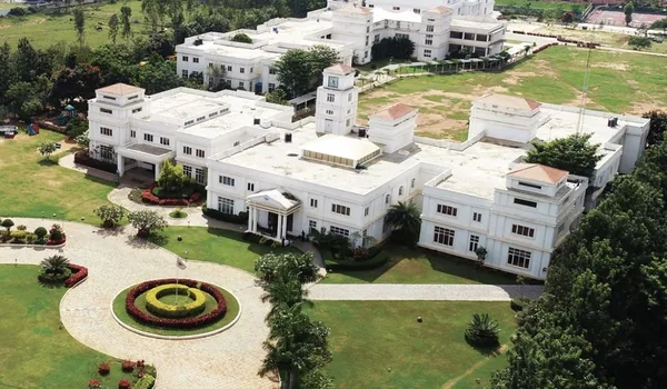 Candor International School Candor International School, Bangalore — white campus buildings, lawns and the circular entrance drive seen from above
