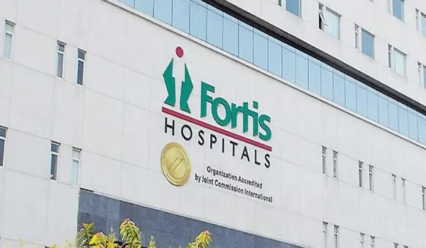 Fortis Hospital, Bannerghatta Road, Bangalore — the Fortis Hospitals wordmark and Joint Commission International accreditation seal mounted on the building facade