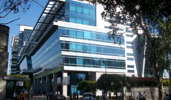 IBC Knowledge Park IBC Knowledge Park, Bangalore — glass and steel office towers seen from the street, with the gated entrance and pedestrians in front