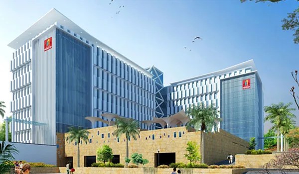 Primeco Towers Primeco Towers, Bangalore — two blue-glass office blocks linked above a stone-clad landscaped podium